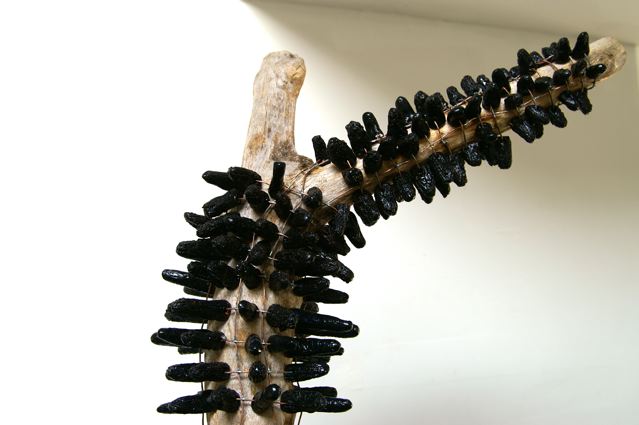 Brigitte Bouquet. Burned Tree (detail), 2009. ceramic, copper, wood. dimensions variable.